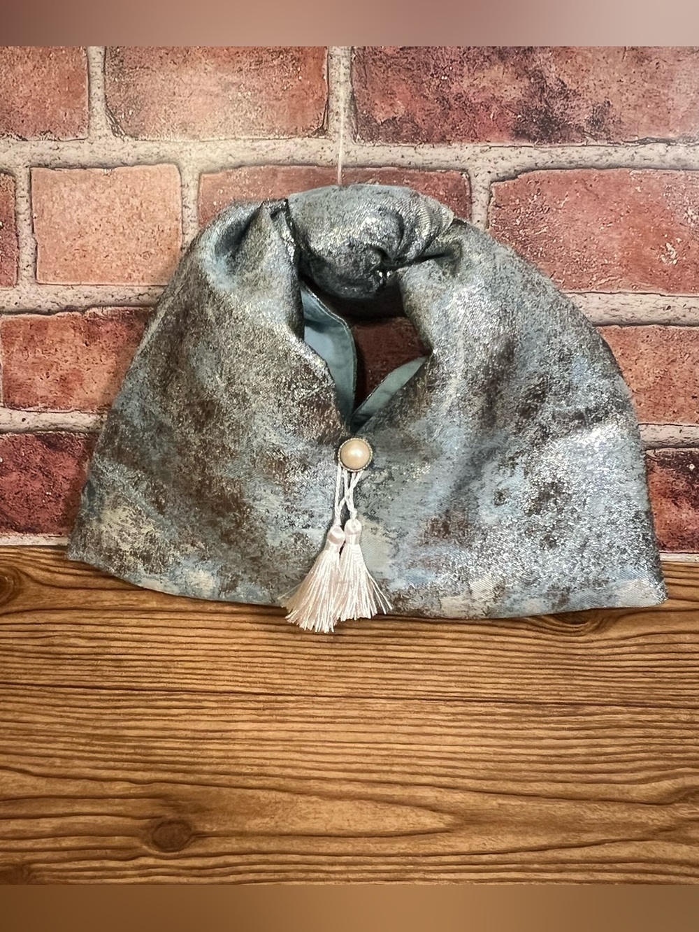 Stylish Blue Metallic Knot Bag with Tassel and Pearl Accent
